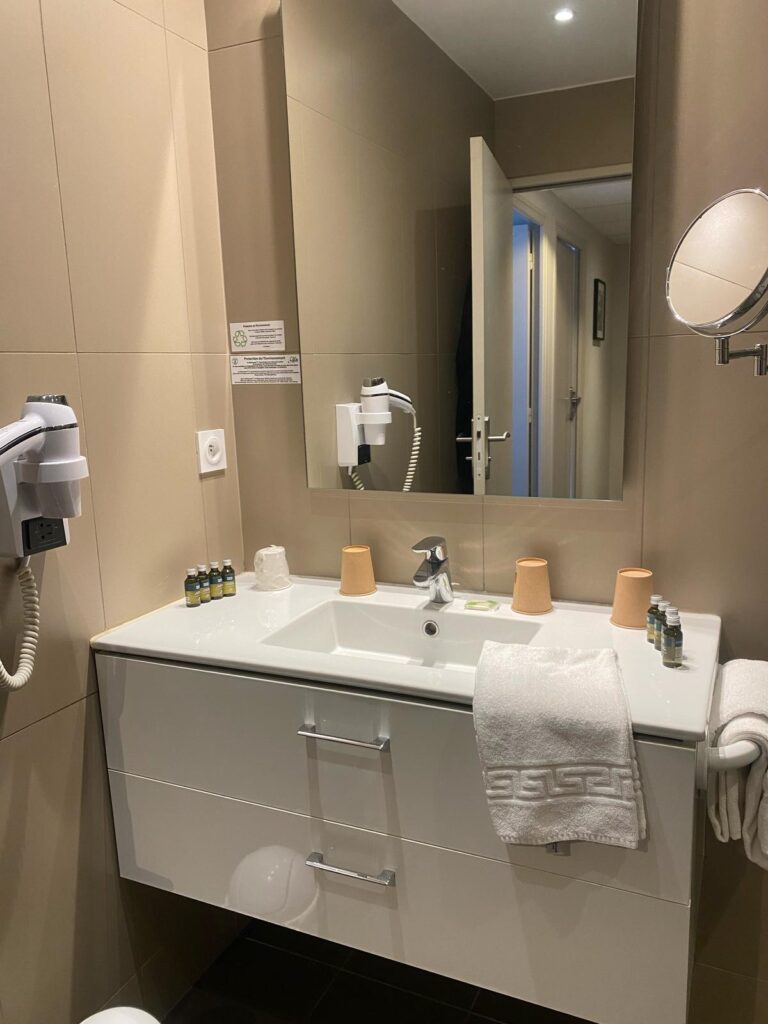 Salle de bains avec vasque sur meuble blanc et miroir